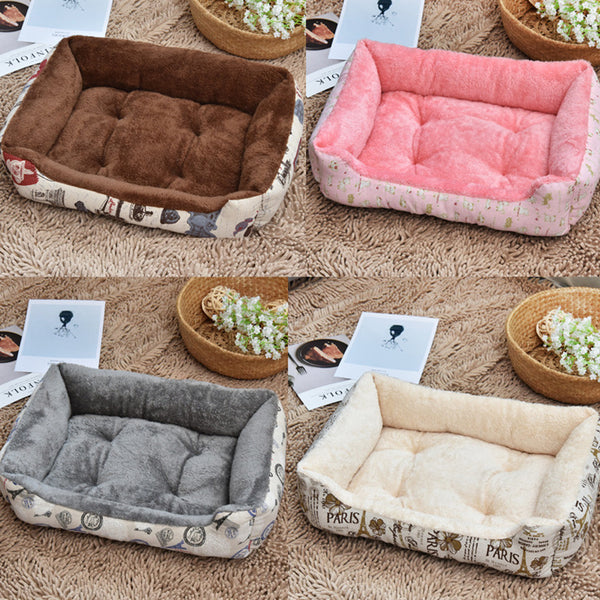 Four different colored pet beds on a textured surface with decorative elements.